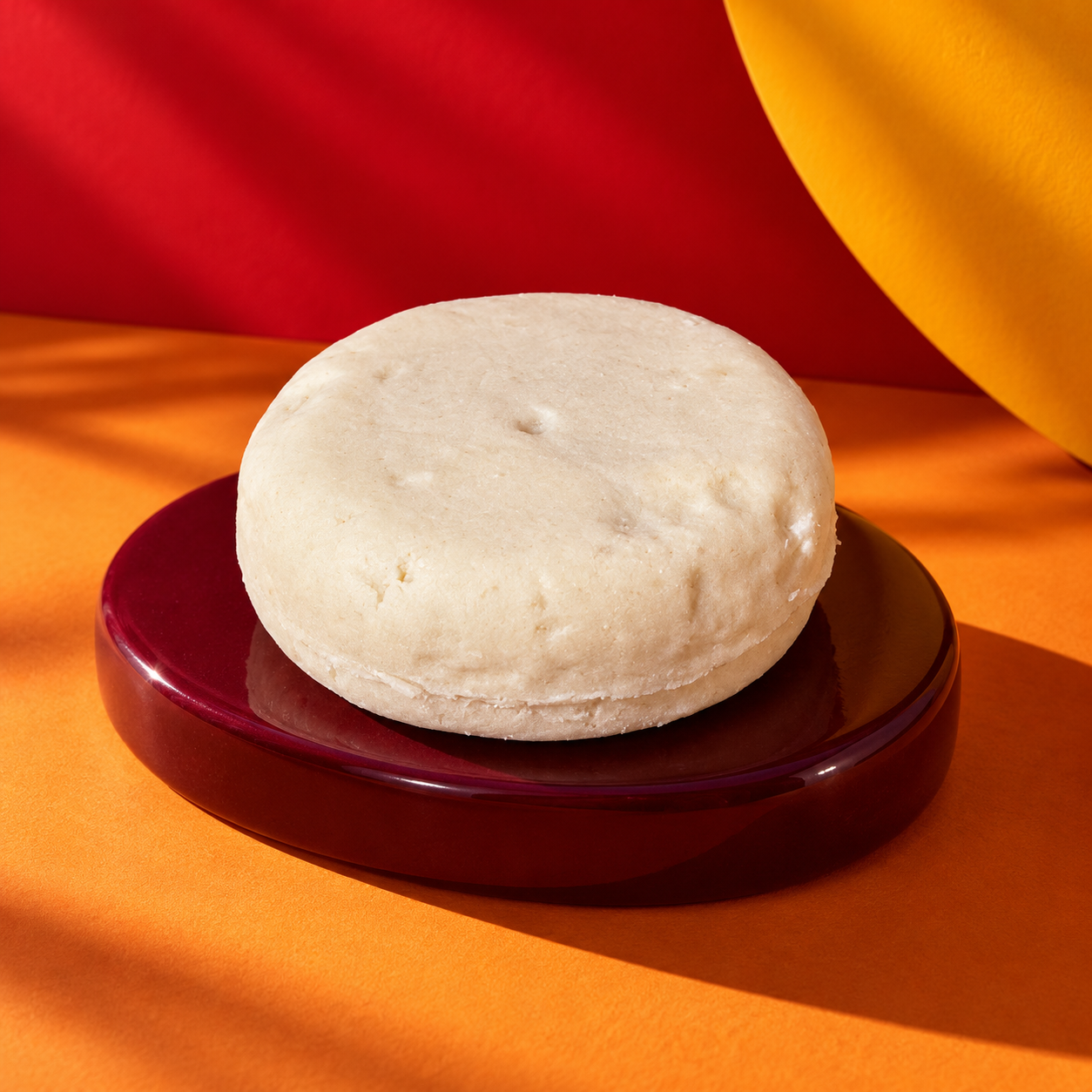 Grandma's Cider shampoo bar on a burgundy dish in autumn light